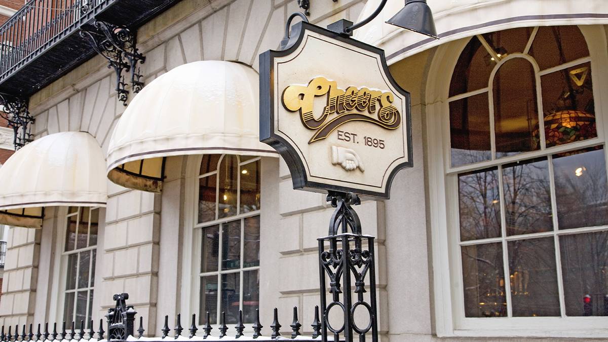 Close of the exterior and golden sign for the Cheers Bar on a sunny day in Boston, Massachusetts, USA